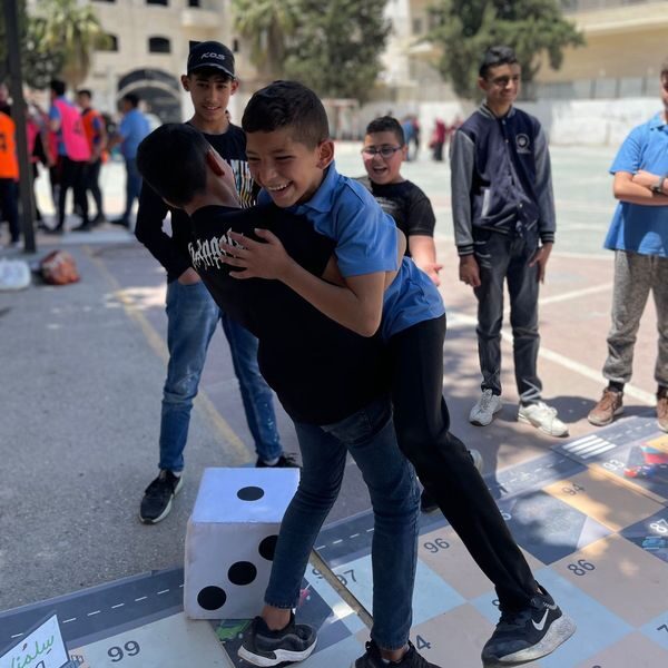 Boys laughing together in a schoolyard